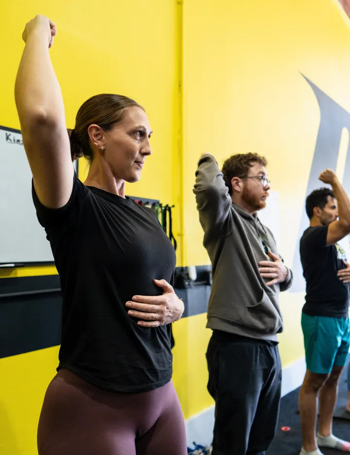 Instructor leading a group mobility class at Motive Training
