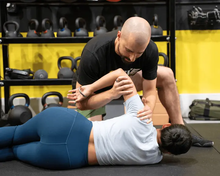 Coach working through a shoulder position with a member at Motive Training