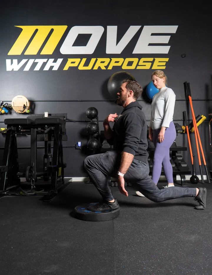 Personal trainer South Austin demonstrating mobility-focused exercises to fight pain.
