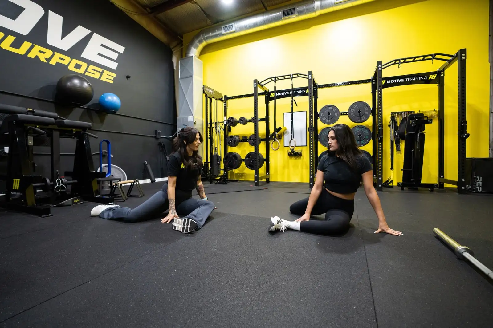 Coach and client in a floor mobility session at Motive Training in South Austin